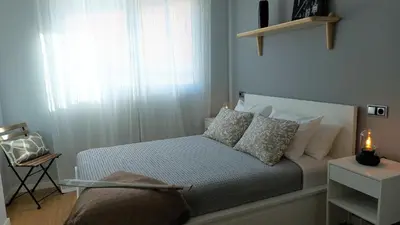 a small bedroom with a bed and a window at Avante24 in Puentedeume