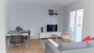 a living room with a couch and a table with a tv at Avante24 in Puentedeume