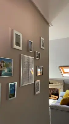 a living room with pictures on a wall at Alfonso Vll in Caldas de Reis