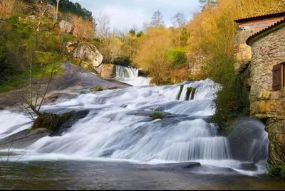 a stream of water flowing down a river at Alfonso Vll in Caldas de Reis