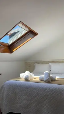 a bedroom with a large bed with a window on it at Alfonso Vll in Caldas de Reis