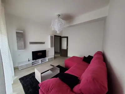 a living room with a red couch and a tv at Piso termal III in Ourense