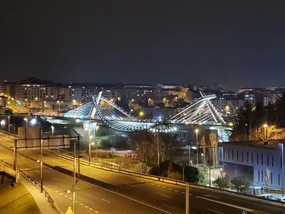 a bridge over a city at night with lights at Piso termal III in Ourense