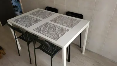 a white table with four chairs around it at Piso termal III in Ourense