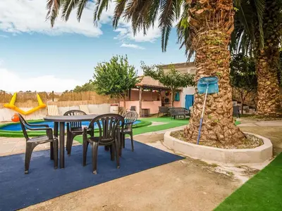 a table and chairs in a yard with a playground at Apartment near Santiago de Compostela in Eirapedriña