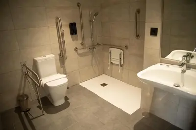 a bathroom with a toilet and a sink at Hotel Chips Fene in Fene