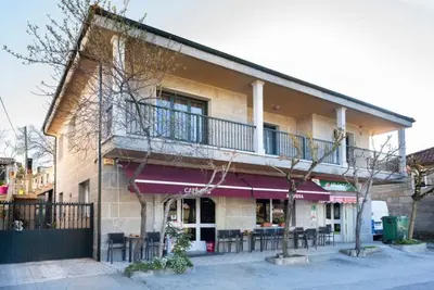 a building with a balcony on the side of it at A Pousa Pensión rural (Camino de Santiago Sanabrés) in Armariz