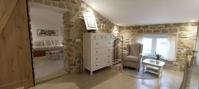 a room with a dresser and a bedroom at O Berce Padrón casa rural in Padrón