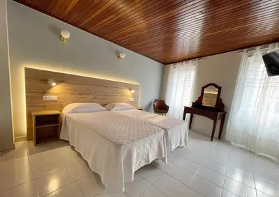 a bedroom with a large bed with a wooden ceiling at Grupo Las Catedrales - Hotel Amadora in Barreiros