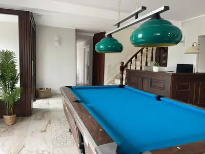 a pool table in a living room with two green lights at Grupo Las Catedrales - Hotel Amadora in Barreiros