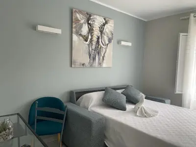 a bedroom with a bed and a painting on the wall at Grupo Las Catedrales - Hotel Amadora in Barreiros