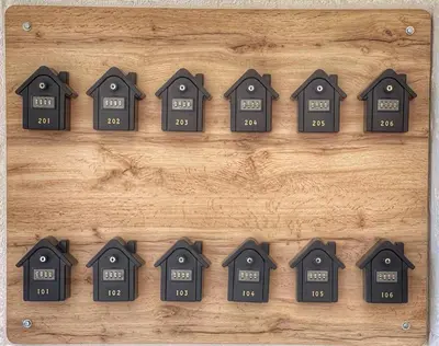 a row of houses with clocks on a wooden table at Grupo Las Catedrales - Hotel Amadora in Barreiros
