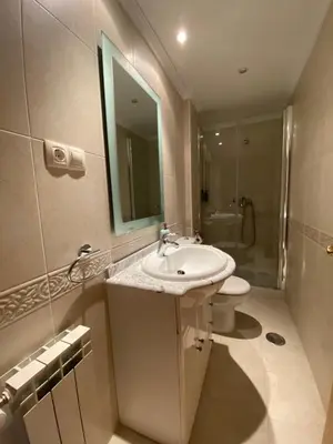 a bathroom with a sink and a toilet and a mirror at Apartamento Marexada Foz in Foz