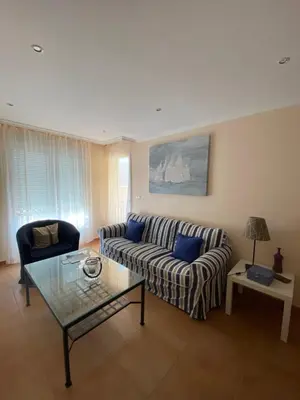 a living room with a couch and a table at Apartamento Marexada Foz in Foz