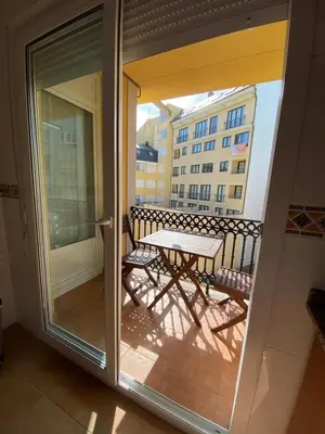 a sliding glass door with a table on a balcony at Apartamento Marexada Foz in Foz