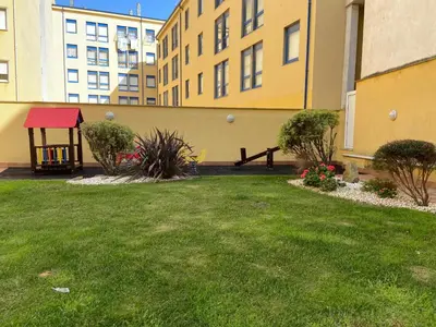 a green yard with a picnic table and some buildings at Apartamento Marexada Foz in Foz