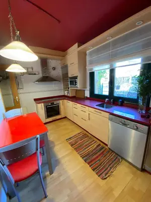 a kitchen with a red table and a red counter top at Casa Loureal Ribeira Sacra Ourense in Ourense