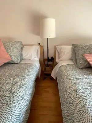 two beds sitting next to each other in a room at Casa Loureal Ribeira Sacra Ourense in Ourense