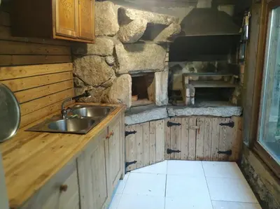 a kitchen with a sink and a stone wall at Casa Loureal Ribeira Sacra Ourense in Ourense