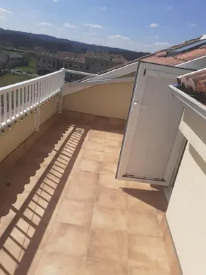 a balcony with sliding doors on a building at Pension Ameneiral in O Pedrouzo