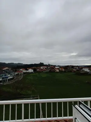 a view of a large green field from a balcony at Pension Ameneiral in O Pedrouzo