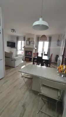 a kitchen and living room with a table and a living room at CASA RURAL PAJARICA en Sanabria in San Ciprián