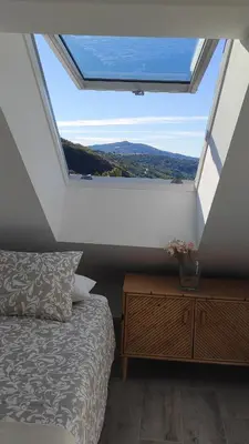 a bedroom with a bed and a large window at CASA RURAL PAJARICA en Sanabria in San Ciprián