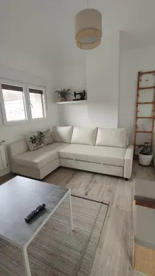 a living room with a white couch and a table at CASA RURAL PAJARICA en Sanabria in San Ciprián