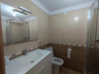a bathroom with a sink and a toilet and a mirror at Porto do Rio in Caldas de Reis