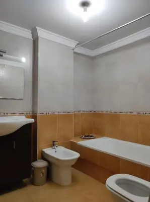 a bathroom with a tub and a toilet and a sink at Porto do Rio in Caldas de Reis