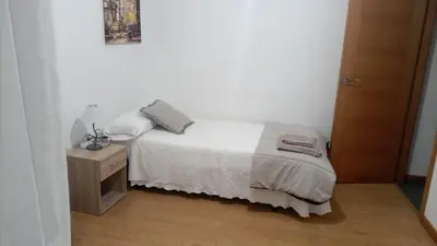 a small bedroom with a bed and a night stand at Porto do Rio in Caldas de Reis