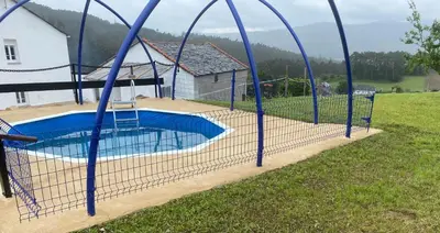 a batting cage around a swimming pool at Casa Darivas in Trabada