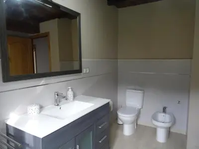 a bathroom with a sink and a toilet and a mirror at Casa Darivas in Trabada