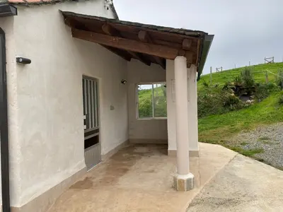a porch of a house with a window at Casa Darivas in Trabada