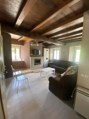 a living room with a couch and a table at Casa Darivas in Trabada