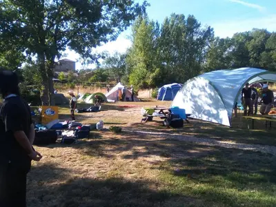 a group of people in a field with tents at Albergue La Senda in Rabanal del Camino