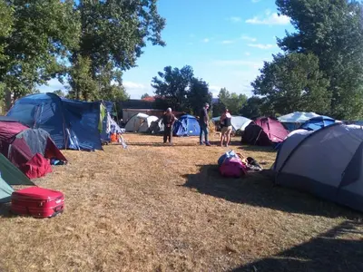 a group of people standing in front of tents at Albergue La Senda in Rabanal del Camino