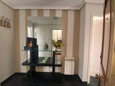 a room with a glass table and a mirror at Casa Lúa in Castro Caldelas