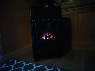 a fireplace in a room with a fire in it at Charming House in Parada with Large Garden in Parada