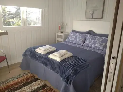 a bedroom with a blue bed with towels on it at Charming House in Parada with Large Garden in Parada