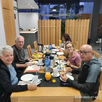 a table topped with plates of food and fruit at Praza Camelias in Sarria