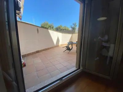 a sliding glass door with a view of a patio at Apartamento a 5 min caminando de la Playa Sta. Cristina, Oleiros (Terraza, Parkin, ) in Oleiros