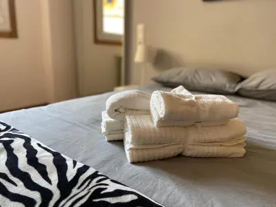 a pile of towels sitting on top of a bed at Apartamento a 5 min caminando de la Playa Sta. Cristina, Oleiros (Terraza, Parkin, ) in Oleiros