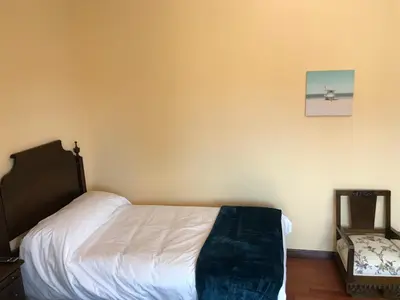 a bedroom with a bed and a picture on the wall at Hotel Batán in Villalba