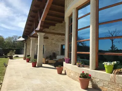 a patio of a house with potted plants at Hotel Batán in Villalba