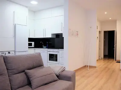 a living room with a couch and a kitchen at Apartment in Ourense near Hot Springs in Ourense