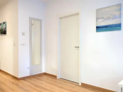 a white door in a room with a wooden floor at Apartment in Ourense near Hot Springs in Ourense