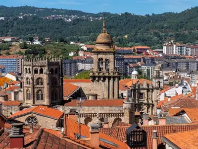 an old building with a clock tower in a city at Apartment in Ourense near Hot Springs in Ourense
