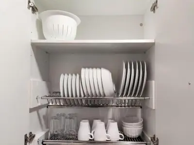a kitchen with white plates and utensils in a refrigerator at Apartment in Ourense near Thermal Baths in Ourense