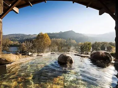 a swimming pool with rocks in the water at Apartment in Ourense near Thermal Baths in Ourense